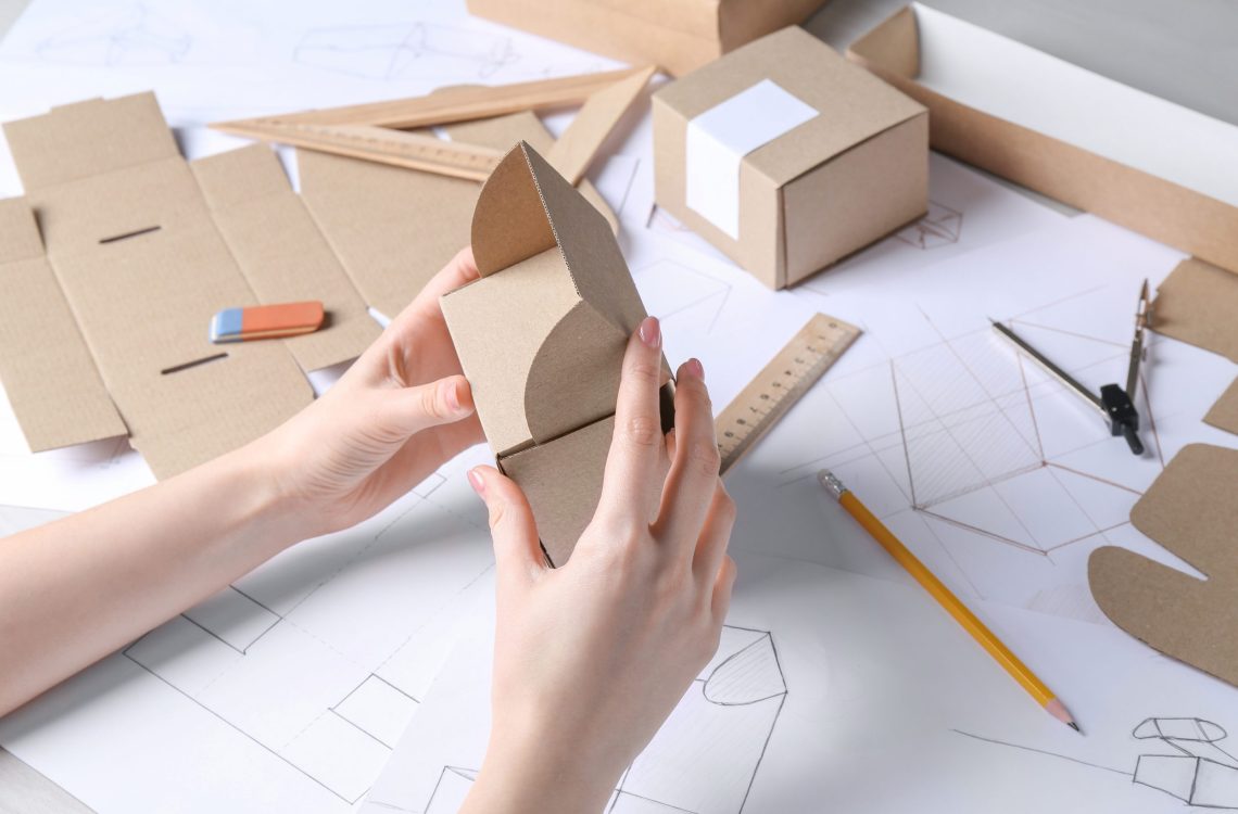 Woman creating packaging design at table, closeup
